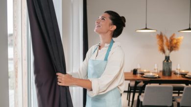 A girl folding her custom curtains UK online