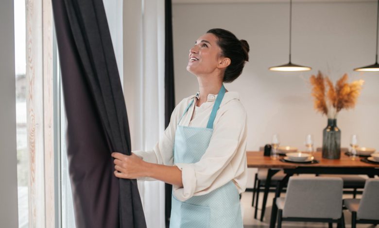 A girl folding her custom curtains UK online