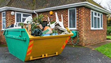 Skip bins in house backyard