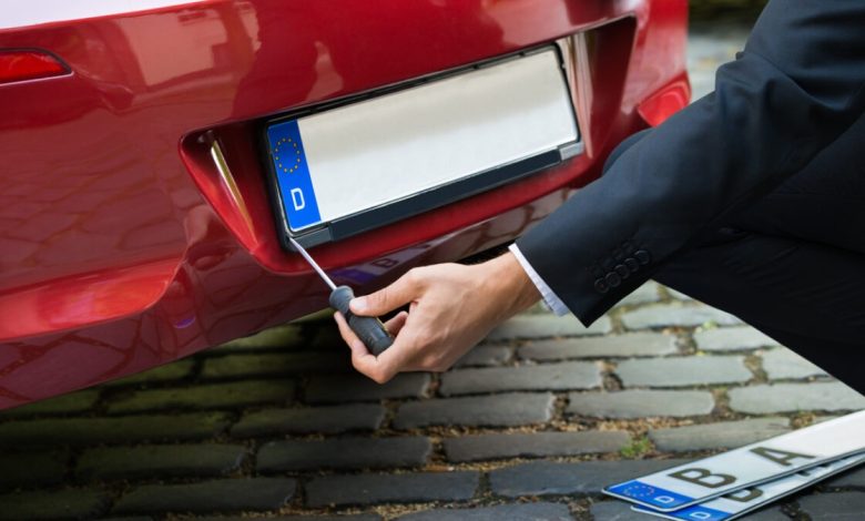 A man fixing his car Number Plate Sticky Pads