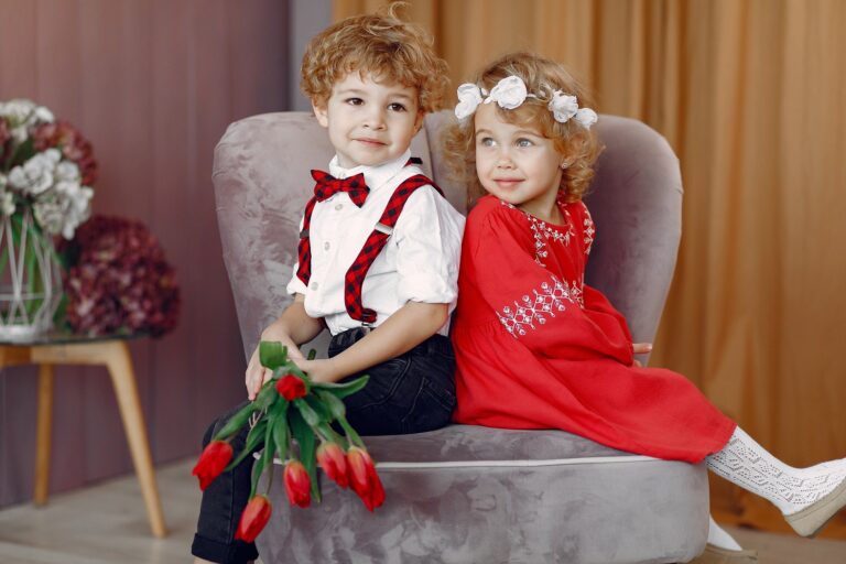 Elegant little kids in a studio with bouquet of tulip