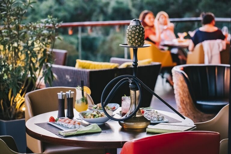 side view served table with sushi and pineapple shisha