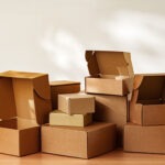 Stacked Cardboard Boxes On Wooden Surface In Sunlight close up